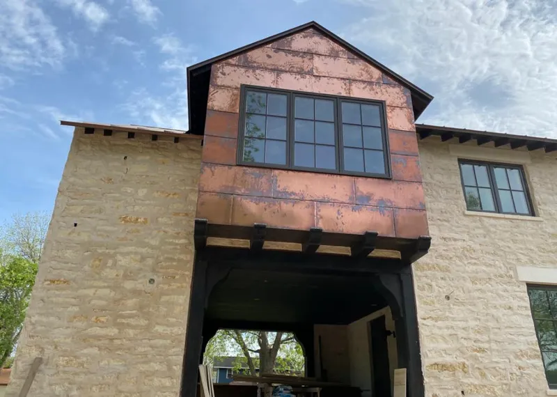 Copper metal panel facade on a stone building for Skylight Installation in Tucker